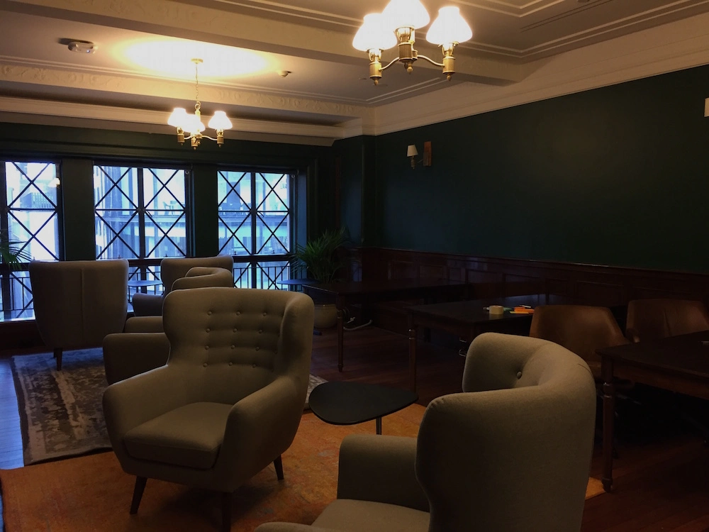 A room with leather chairs and mahogany desks